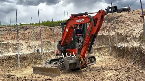 how to put a track back on a mini excavator|mini excavator track release.